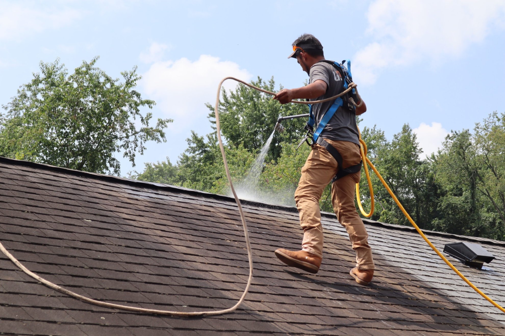 Before and after comparison of a home showing aged, streaky shingles on the left transformed to a clean, rejuvenated roof on the right after UglyRoof treatment